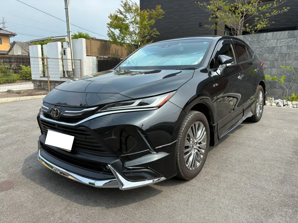 Black Toyota SUV parked on pavement, front-left angle showing chrome grille and sleek headlights.
